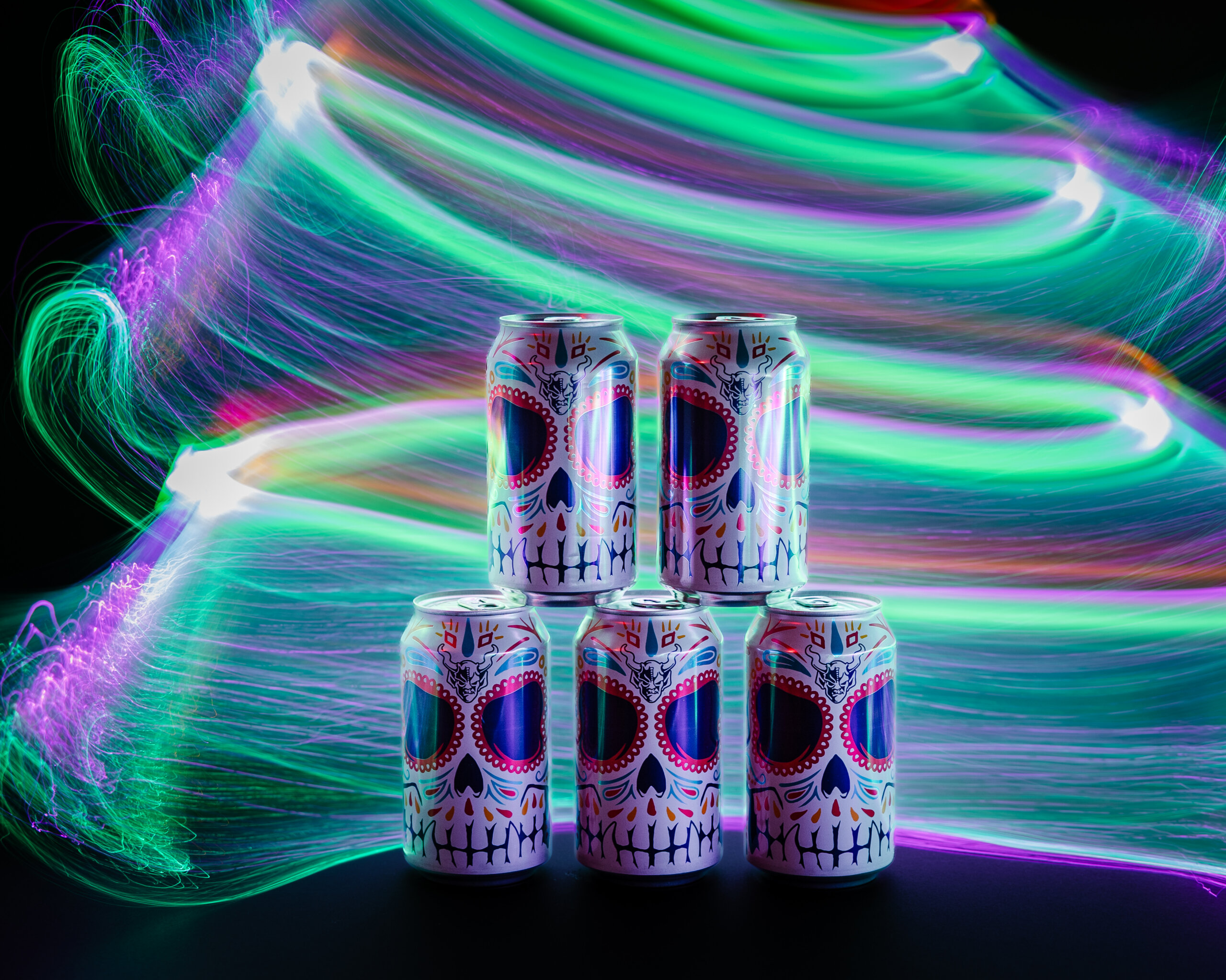 5 cans of Stone Buenaveza stacked with color effect in the background